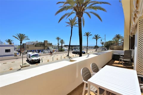 Sunny terrace with outdoor dining area and sea views