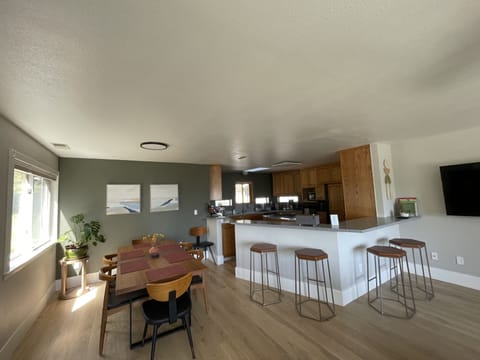 Open dining area and kitchen with 4 bar stools