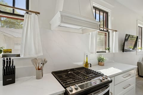 Sleek kitchen with quartz counters, stainless steel appli, and a spacious layout