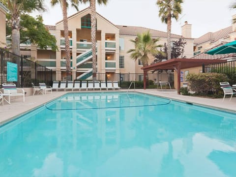 Float peacefully in the sparkling pool with ample loungers.