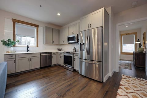 Embrace the elegance of stainless steel and hardwood in this stunning kitchen design that combines luxury and durability seamlessly.