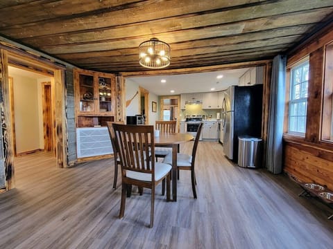 Enjoy the rustic charm of the old cabin with the exposed ceiling and siding