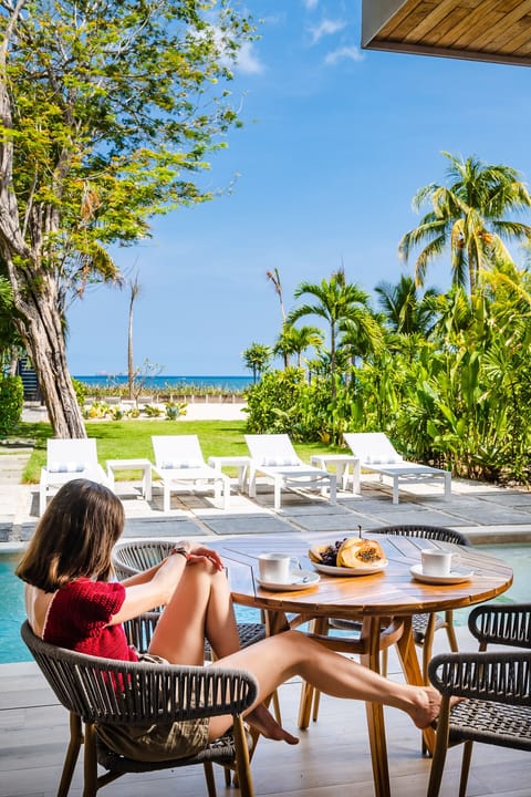 Breakfast is served. Poolside patio overlooking the villa grounds and the ocean 