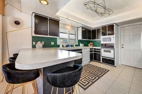 Cooky kitchen and island with bar stools.