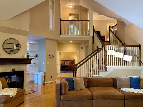 Open main level LR with vaulted ceiling, double-sided fireplace.