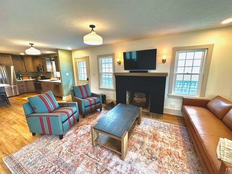 Living room w/ recliners, couch, 50" SmartTV, Sonos sound bar w/ subwoofer.