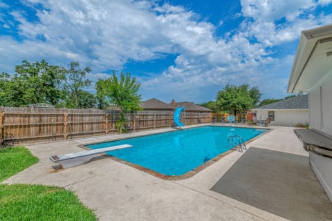 10 feet deep, 1500 square foot pool! With diving board and waterslide.
