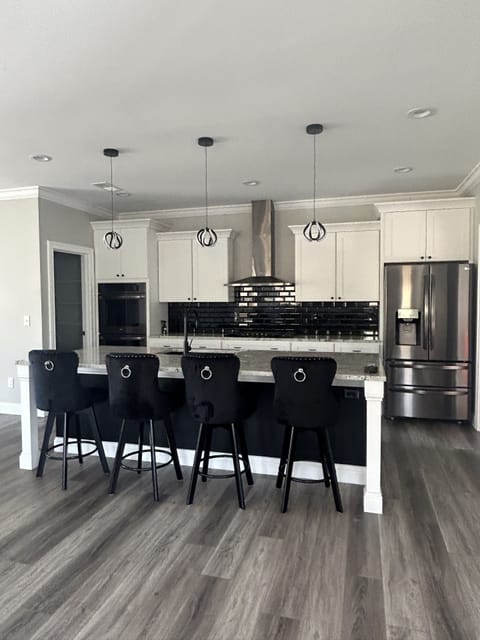 Kitchen with double oven, gas range, bar and walk-in pantry.