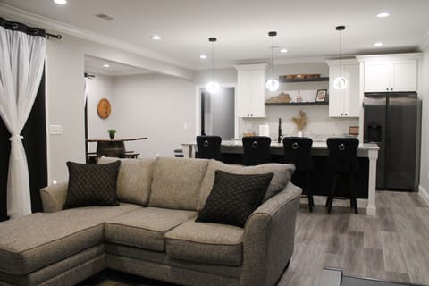 Basement living room with view of the bourbon bar. There is also a 65" Roku tv.