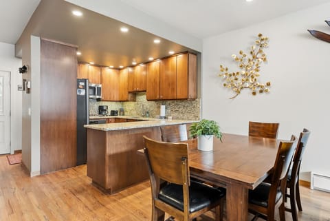 Your open kitchen and dining space features warm wood cabinetry, granite countertops, and modern appliances for memorable meal preparation.