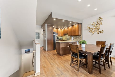 Step into your open-concept kitchen and dining space where warm wood finishes create the perfect atmosphere for memorable meals together.
