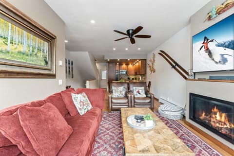 Cozy up by your crackling fireplace after mountain adventures, with plush seating and an open kitchen perfect for sharing stories.