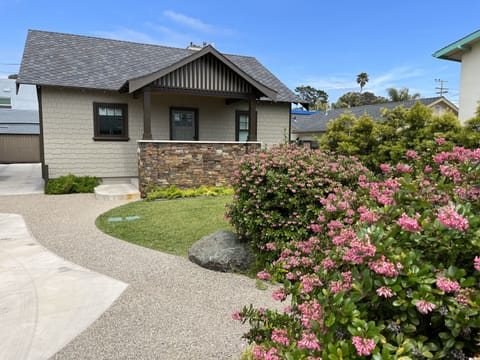 Front of cottage with potion of large patio parking area and lawn