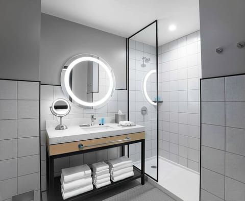 Refresh under a sleek glass shower and bright vanity.