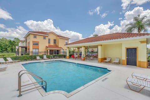 Outdoor pool area with lounge chairs and shaded seating for relaxing.