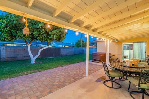 Enjoy a sonoran sunset on the beautiful patio with mountain views, surrounded by lush green grass and one of Arizona's famous citrus trees