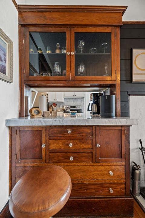 Bar is stocked with glassware, wine opener and stoppers.