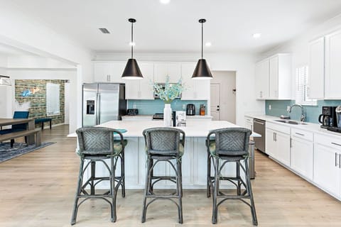 Open Kitchen Design with Large 3-Seat Island Makes It the Hub for Activities