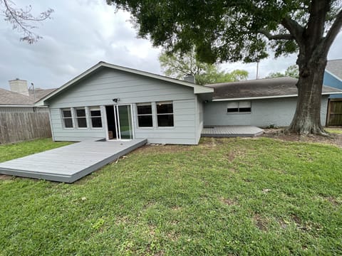 Back of the house. Fenced in. Patio furniture. Corn hole games available