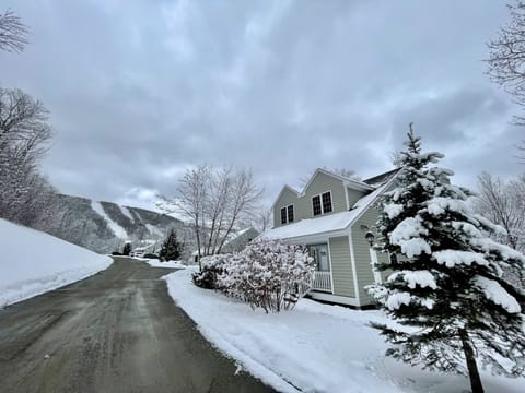 Winter exterior photo of house and mountain view of Jiminy Peak