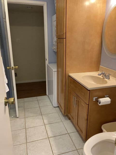 Full bathroom with washer and dryer