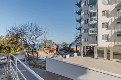An exterior view of the building, highlighting the modern architecture and surrounding greenery.
