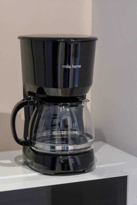 A close-up of a black coffee maker, perfect for preparing fresh coffee during your stay.
