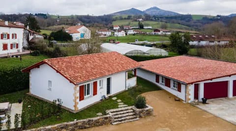 Newly built house next to the river and ancient Espelette lavoir.