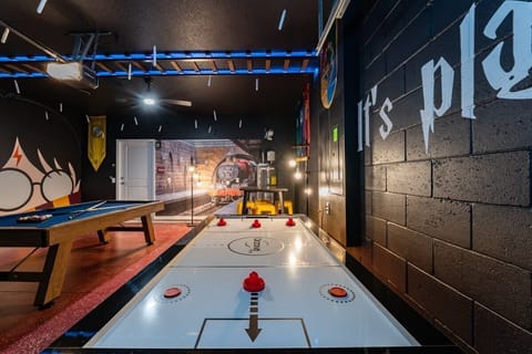 Dive into a magical game room adventure with themed decor, pool, and air hockey tables for endless fun!