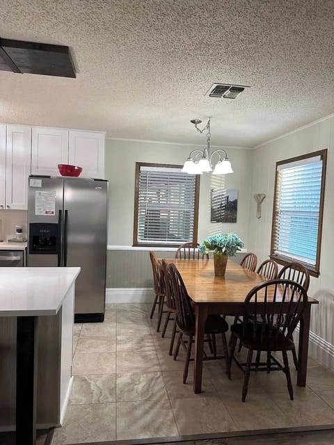 Spacious dining table comfortably accommodates 8 guests with ample room for serving dishes and a stylish centerpiece.