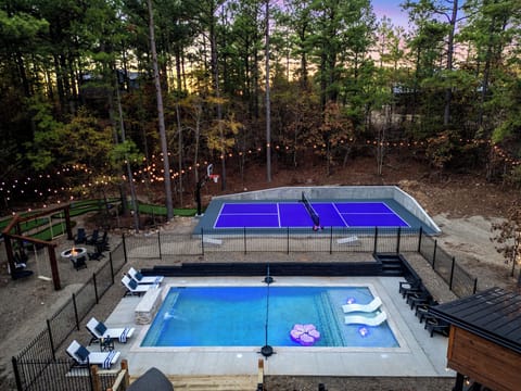 Your Year-round Retreat! Relax by the heated pool, play pickleball or basketball, and enjoy glow golf under towering pines. Relax on swings or loungers! 
