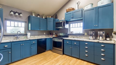 This property's fully equipped and spacious kitchen is a cook's dream come true. You can prepare delicious home-cooked meals w /ample counter space and all the necessary cookware and appliances. It is the perfect space for all your culinary needs.