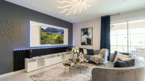 Chic modern living room with sleek decor, LED accents, and poolside views.