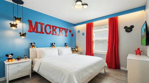 Vibrant Mickey-themed bedroom with playful decor, fun lighting, and cozy vibes.