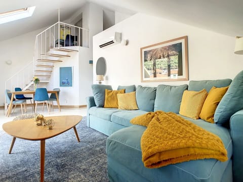 A top-floor apartment adorned with soothing décor, where relaxation takes center stage with this welcoming yellow & blue