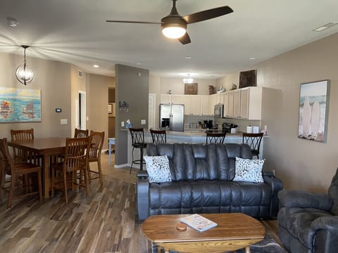 Open concept with view of living area, kitchen and dining.  Note table for 6