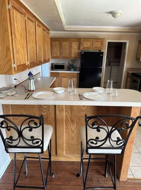 Large kitchen with a bar area with two bar stools 