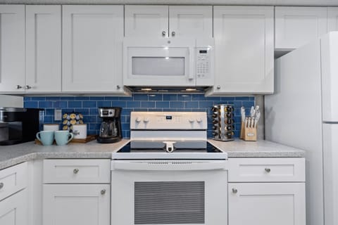 Fully stocked custom kitchen open to the living room.