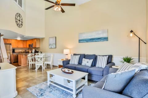 This inviting living room offers a cozy yet elegant space to unwind, with plush seating and a serene coastal aesthetic.