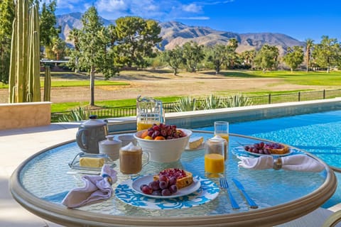 A peaceful and inviting outdoor dining experience, set against a backdrop of natural beauty, making it an ideal spot for enjoying a leisurely meal.