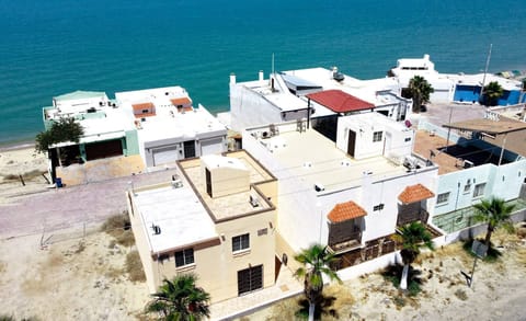 See Casa Seascape from a distance in this drone shot — perched in Villas de Las Palmas with nothing behind it except never-ending desert and mountain views .