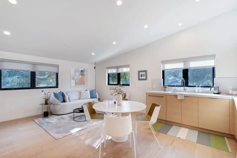 Savor a delightful meal at the dining table with a Terrazzo top, accompanied by designer chairs