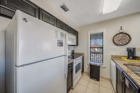 The fully equipped kitchen features granite countertops.
