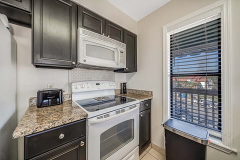 The fully equipped kitchen features granite countertops.