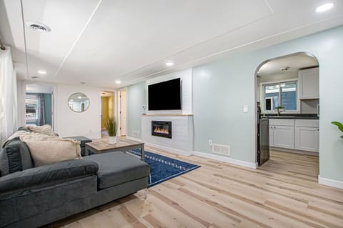 Living room with 65 inch flat screen and LED fireplace.