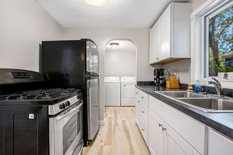 Full kitchen with Black/Stainless Steel appliances. Off the kitchen is a laundry area for your use.