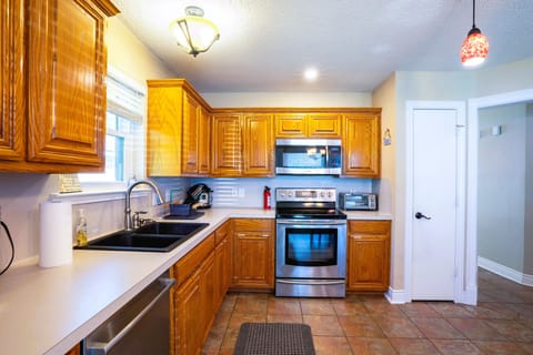 Fully stocked kitchen with modern amenities, designed for extended stays.  