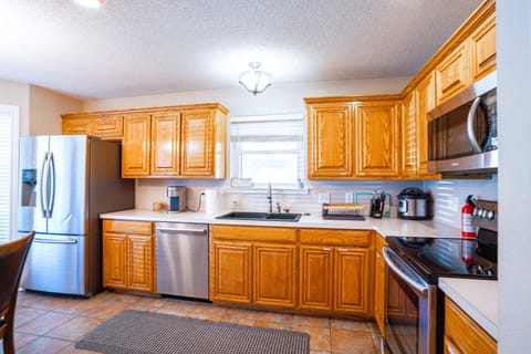 Fully stocked kitchen with modern amenities, designed for extended stays.  