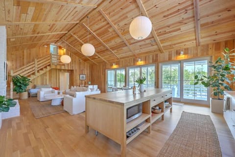 Spacious, open-concept living area with natural wood accents and abundant sunlight.