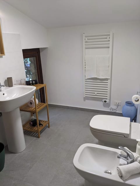 All bathrooms contain a toilet, bidet, sink, heated towel bar, and shower.